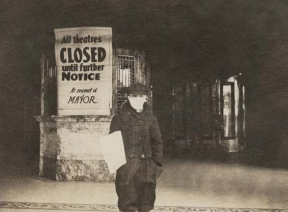 Masked newsboy in front of the Pantages Theatre, Seattle, 1918. (Courtesy Museum of History and Industry, Image No. shs6338B)
