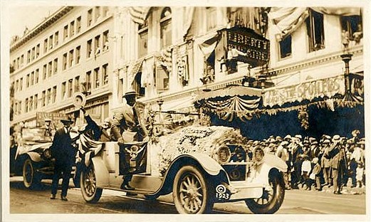 Motorcade for President Warren Harding passes in front of Seattle's Liberty Theatre, July 27, 1923. (Postcard photograph by J. Frost)