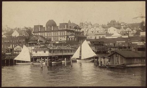 Seattle waterfront, ca. 1885, with Frye's Opera House looming above. (Courtesy Museum of History and Industry, Image No. 200854.31)